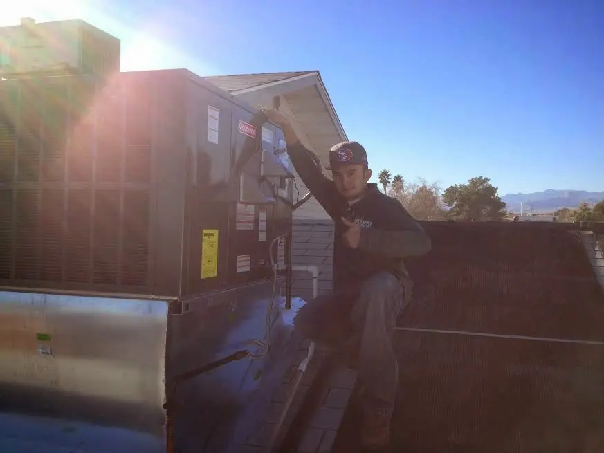 HVAC technician performing HVAC Inspection on a rooftop unit in West Allis